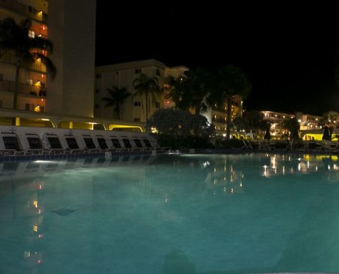 View of the pool at night at Crescent Royale Condominiums in Florida